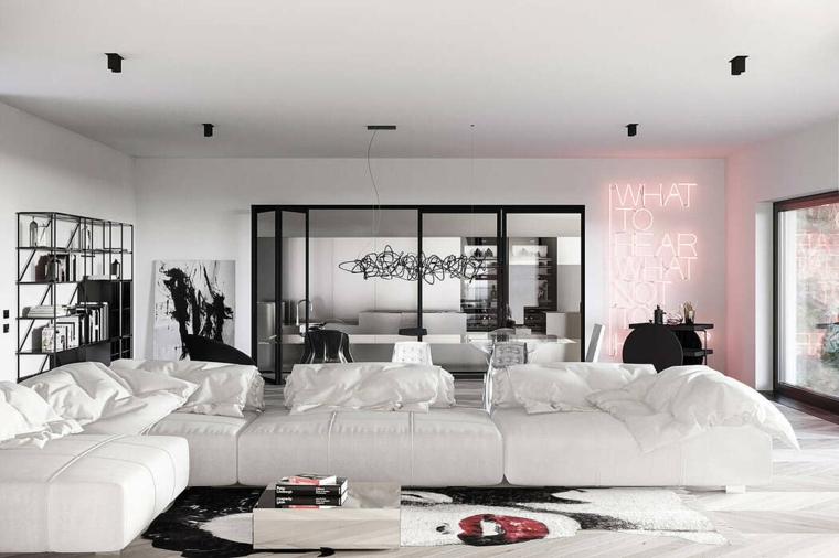 Arredare cucina soggiorno open space, divano in pelle colore bianco, scritta luminosa sulla parete