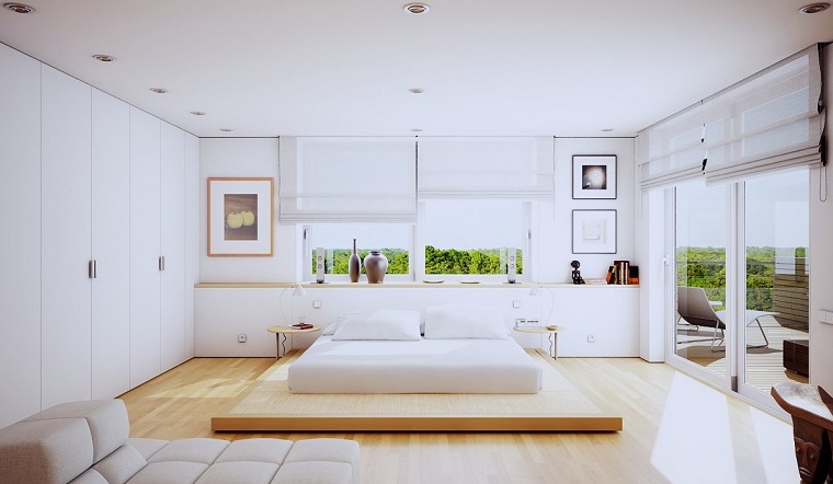 idee-camera-da-letto-stile-moderno-letto-basso-pavimento-legno-quadri-parete-porta-finestra-terrazzo-vista