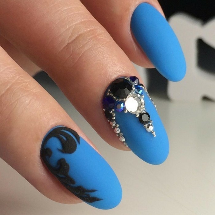 unghie-lunghe-tonde-decorazioni-nere-lato-brillantini-pietre-base-blu-opaca