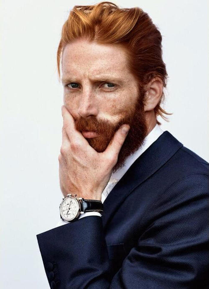 capelli-uomo-medio-lunghi-rossi-pettinati-indietro-folta-barba-giacca-blu-elegante-orologio-vintage