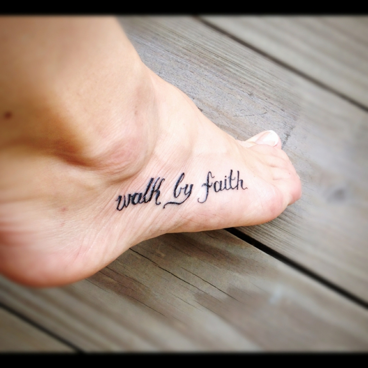 Tatuaggi piccoli caviglia, tatuaggio con scritta sul piede di una donna, pavimento in legno