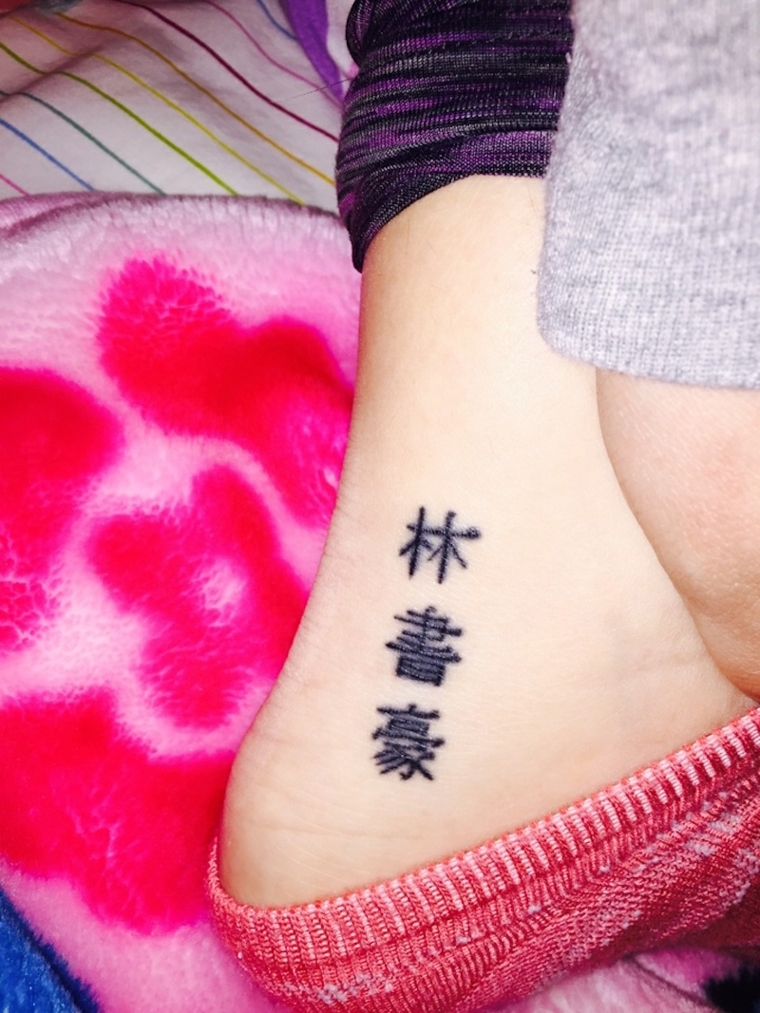 tatuaggio sulla caviglia, delle lettere in carattere orientale nella parte interna