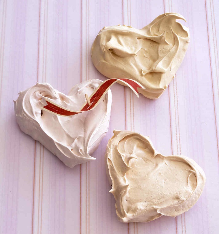 Idea per dolci San Valentino con meringhe a forma di cuore e decorazione con un nastro 