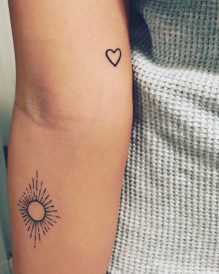 tattoo cuore sul braccio di una donna tatuaggio cerchio sole avambraccio