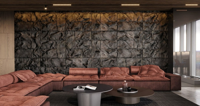 parete in pietra con faretti soggiorno con divano angolare arredamento salotto con due tavolini