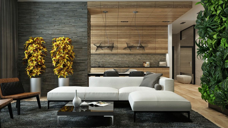 parete in pietra con faretti soggiorno con divano bianco open space cucina salotto