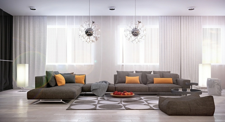Lampadari moderni soggiorno di stile moderno con divano grigio e tavolino molto basso