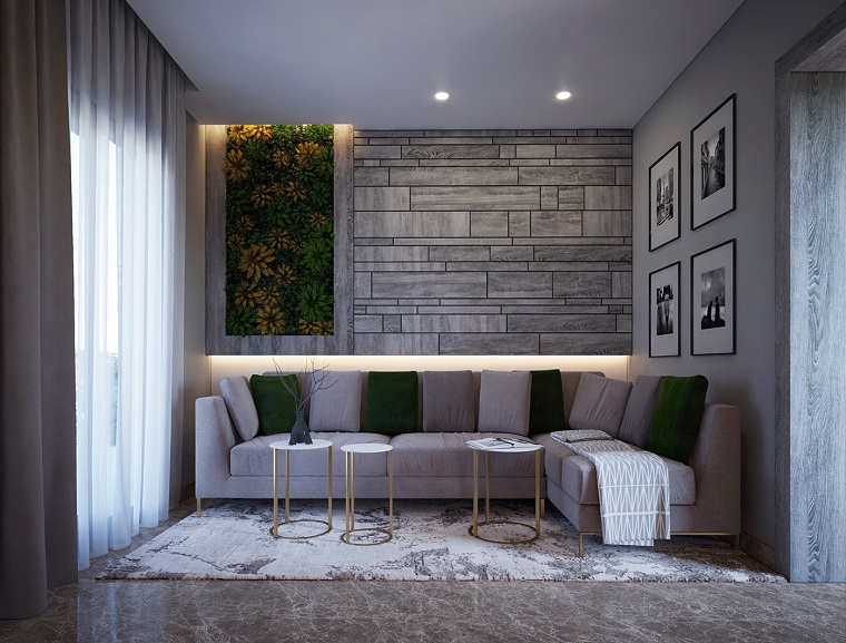 Abbinamento colori pareti nella tonalità del grigio, divano angolare con cuscini verdi 