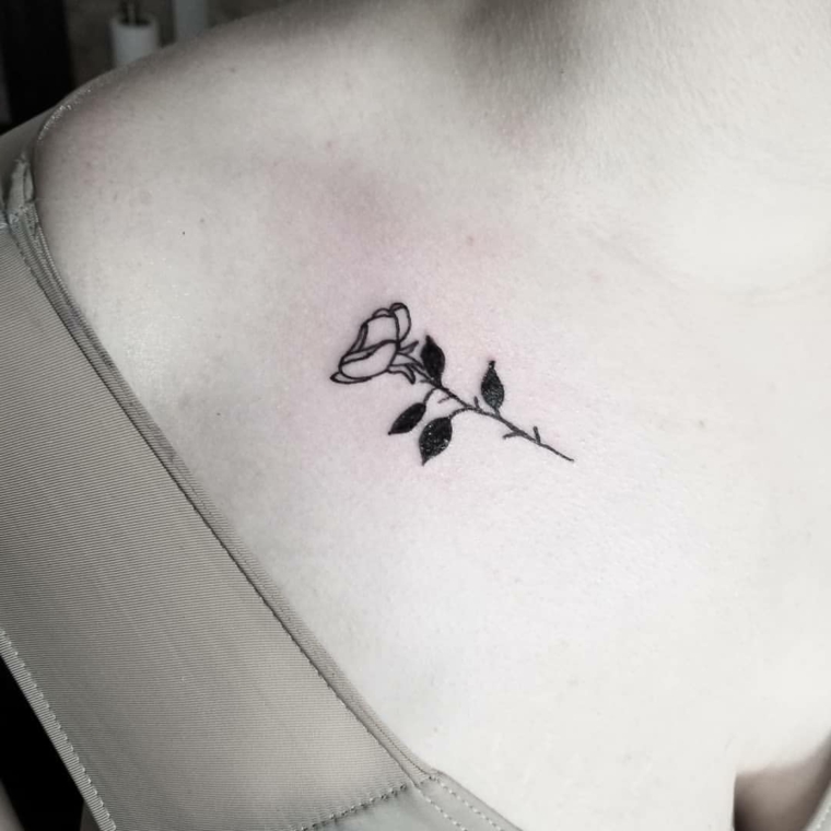 idea per tatuaggi rose piccole con quattro foglie nere appena sotto la scapola