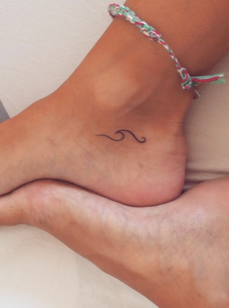 Tatuaggi sul piede femminile con una piccola onda, tatto sulla caviglia semplice