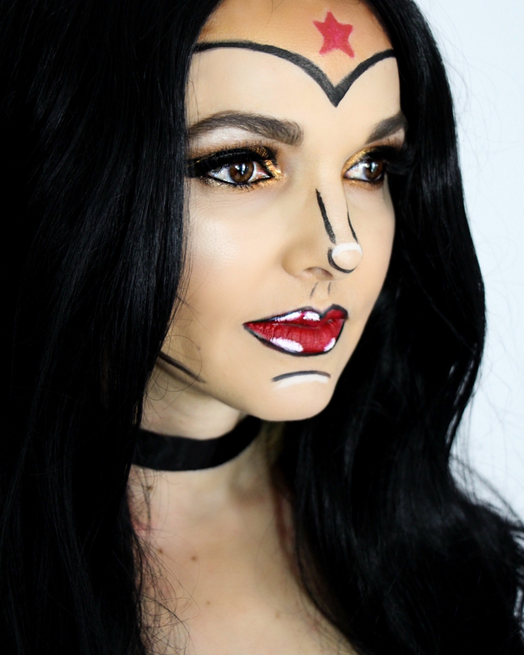 Trucchi per Halloween viso, ragazza con i capelli neri con un make up da Wonder Woman