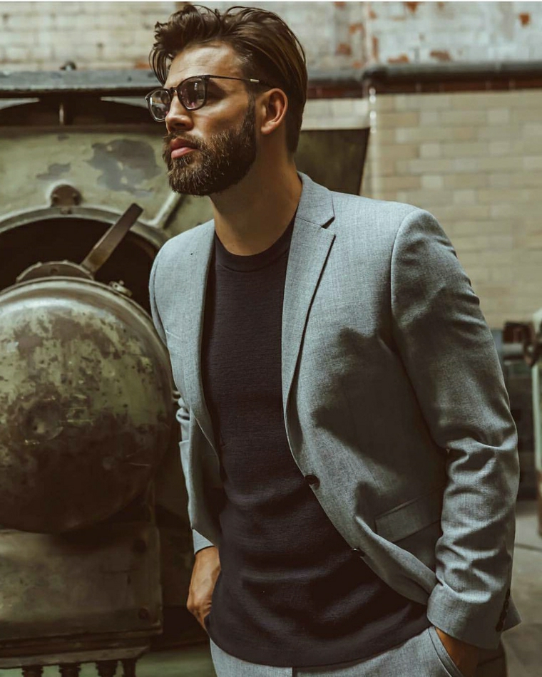 Acconciatura elegante per un ragazzo vestito casual, capelli rasati uomo di colore castano