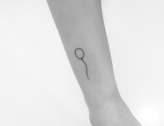 Idee per dei tatuaggi piccoli significativi, tattoo palloncino sul braccio di una donna