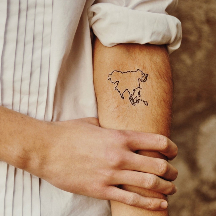 Uomo con tatuaggio sul braccio, disegno continente, tatuaggi più belli