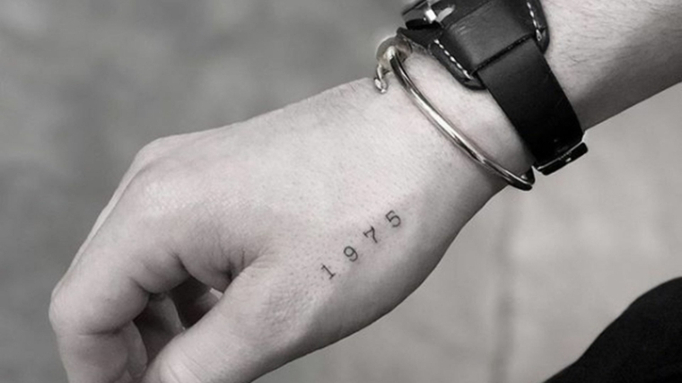 Catalogo tatuaggi, tattoo sul polso della mano, tattoo numero 1975, orologio da polso
