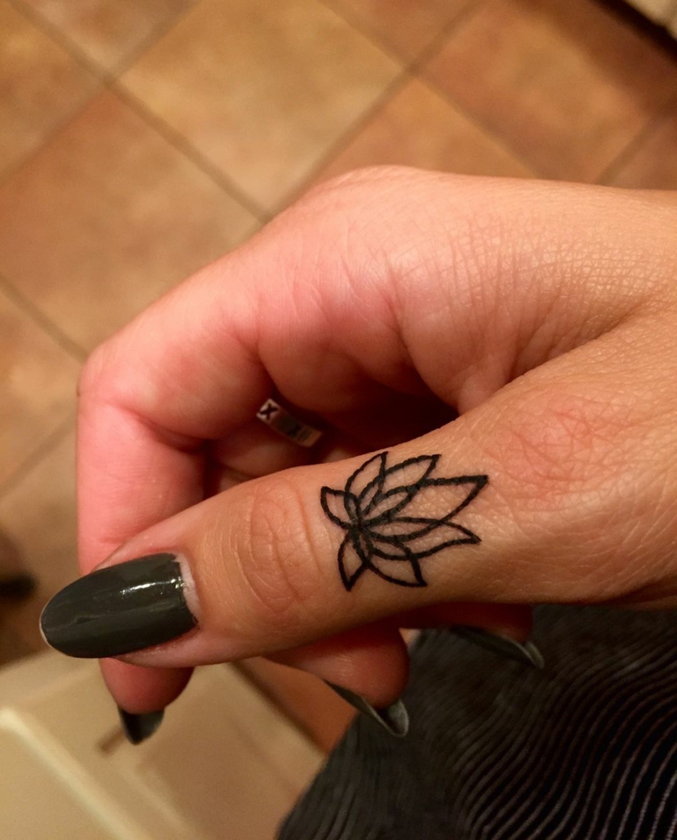 Fiore di loto tatuaggio, tattoo sul dito indice di una mano, piccolo tattoo mandala