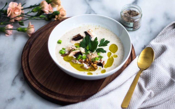 Zuppe dietetiche, vellutata con funghi champignon, zuppa condita con olio e foglie di prezzemolo
