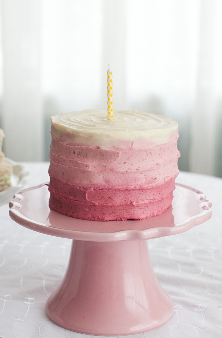 Torta decorata con panna montata colorata, torta di compleanno con candela
