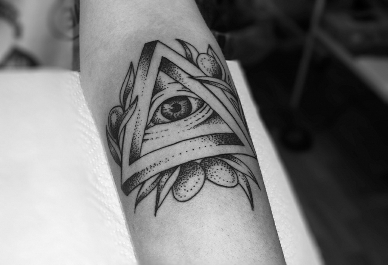 Il braccio di una donna con tatuaggio, tattoo disegno occhio in un triangolo