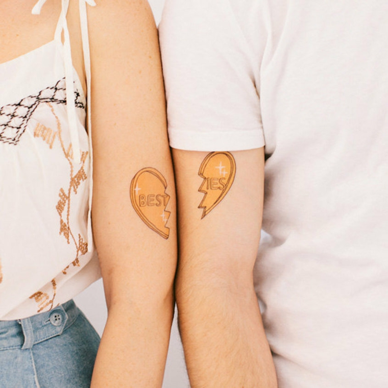 Tatuaggi amiche, tattoo sul braccio con disegno di un cuore spezzato con scritta