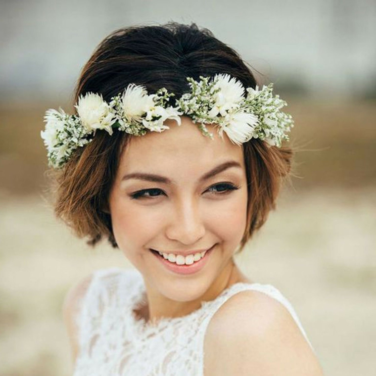 Donna con corona di fiori in testa, taglio di capelli cortissimo di colore castano