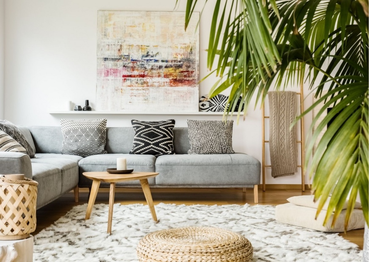 divano angolare grigio decorazione soggiorno con palma