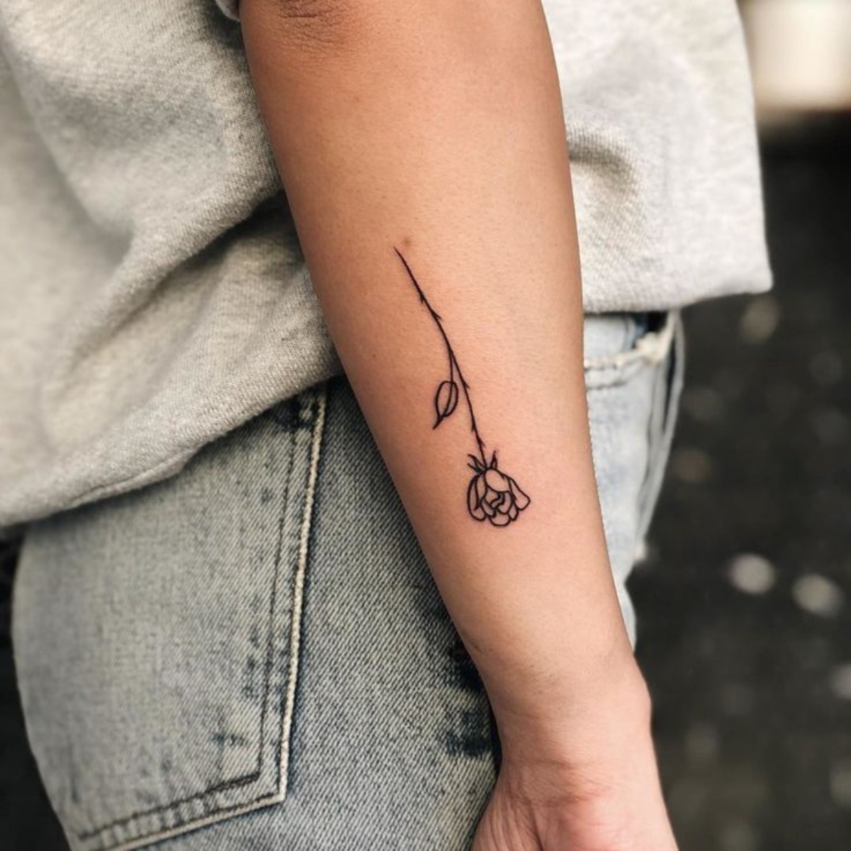 avambraccio donna con disegno di un tatuaggio di rosa