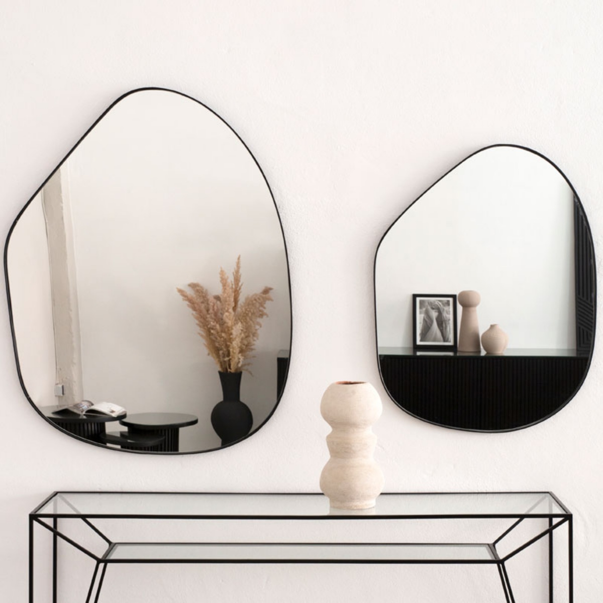 due specchi dalla forma irregolare parete bianca